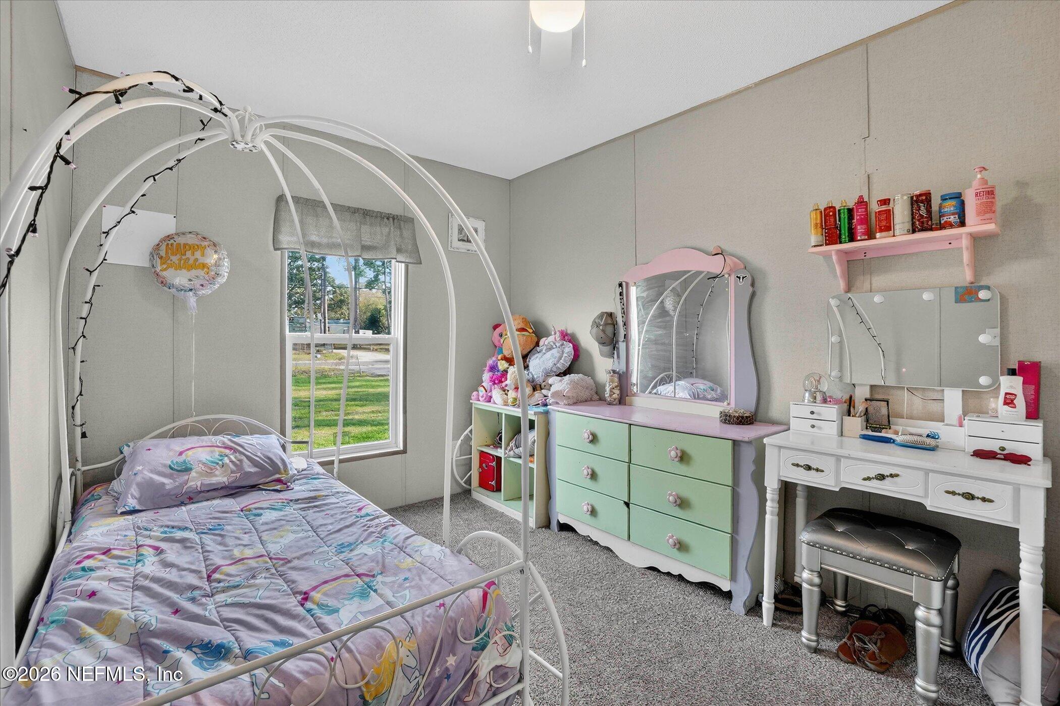 85405 Blackmon Road Yulee, FL 32097 - Photo 15 of 27 a bedroom with a bed and a dresser