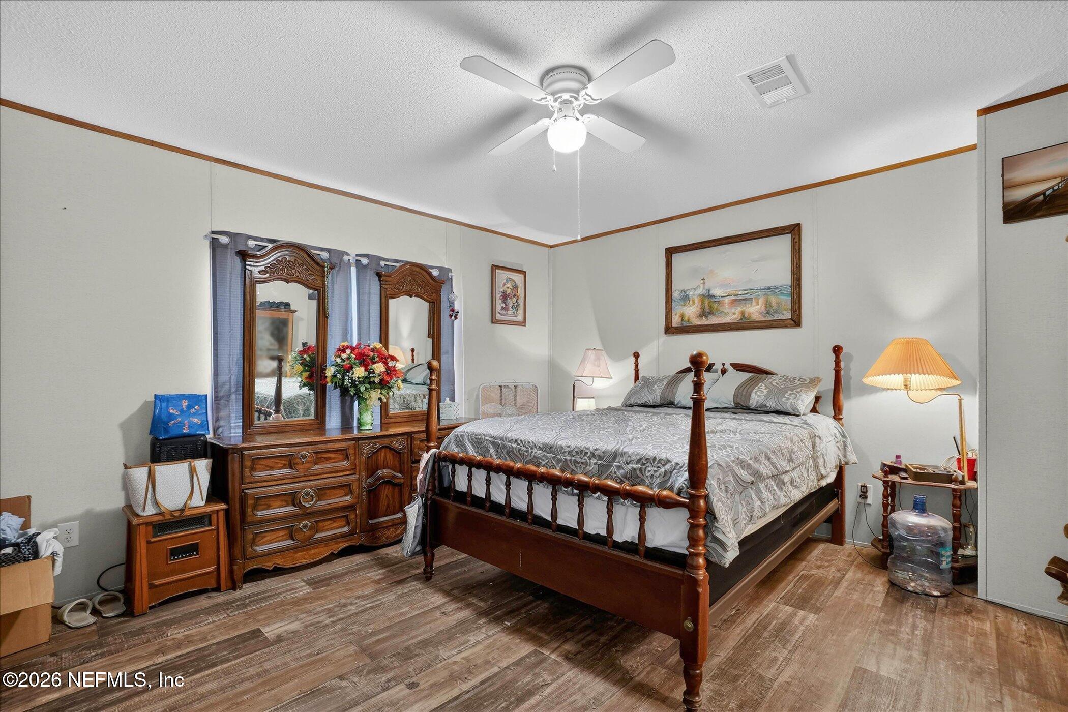 85405 Blackmon Road Yulee, FL 32097 - Photo 17 of 27 a bedroom with a bed and wooden floor