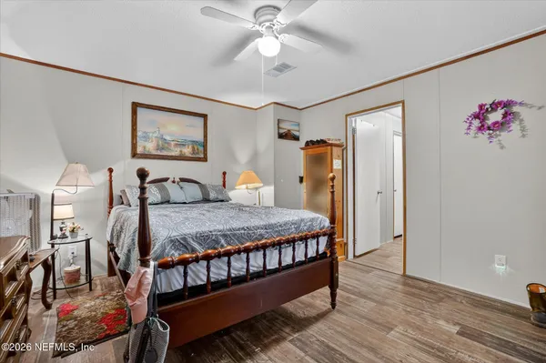 a bed room with a bed and a chandelier