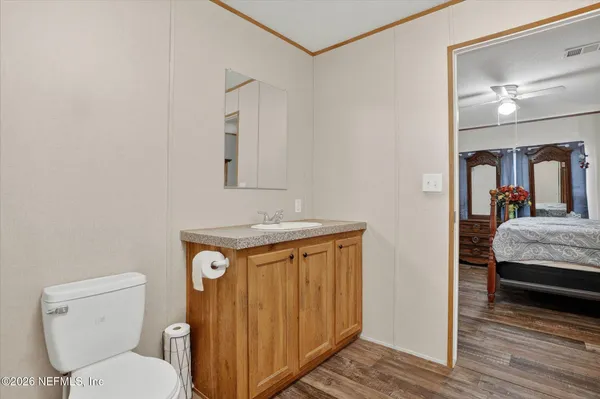 a bathroom with a toilet a sink and mirror