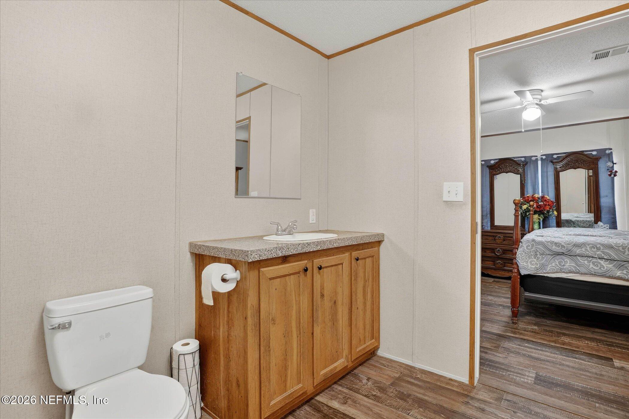 85405 Blackmon Road Yulee, FL 32097 - Photo 20 of 27 a bathroom with a toilet a sink and mirror