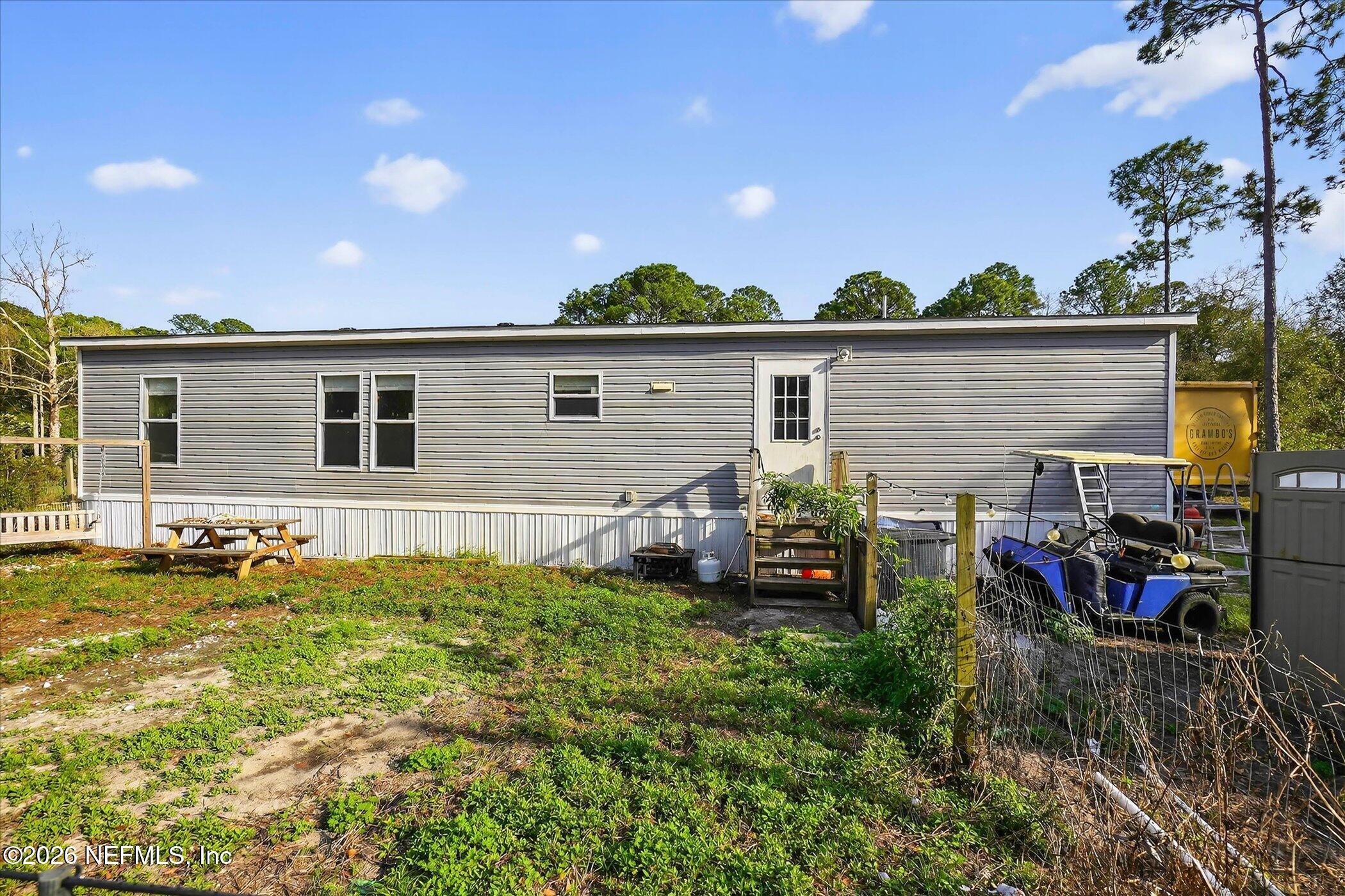 85405 Blackmon Road Yulee, FL 32097 - Photo 23 of 27 a view of a backyard with a patio