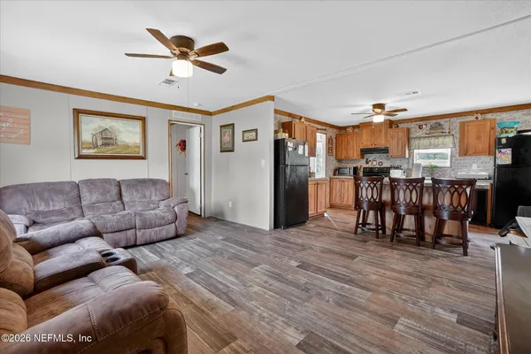 a living room with furniture and kitchen view