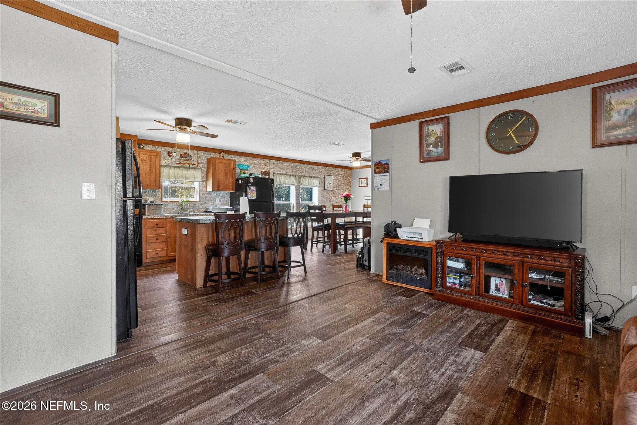 85405 Blackmon Road Yulee, FL 32097 - Photo 5 of 27 a living room with furniture and a flat screen tv