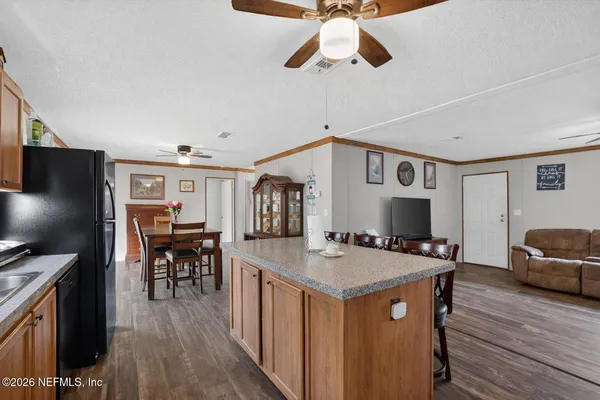 a open kitchen with stainless steel appliances granite countertop a stove and a refrigerator