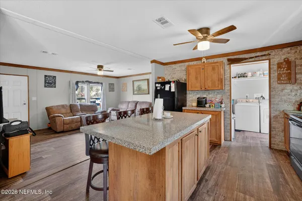 a kitchen with sink cabinets and wooden floor
