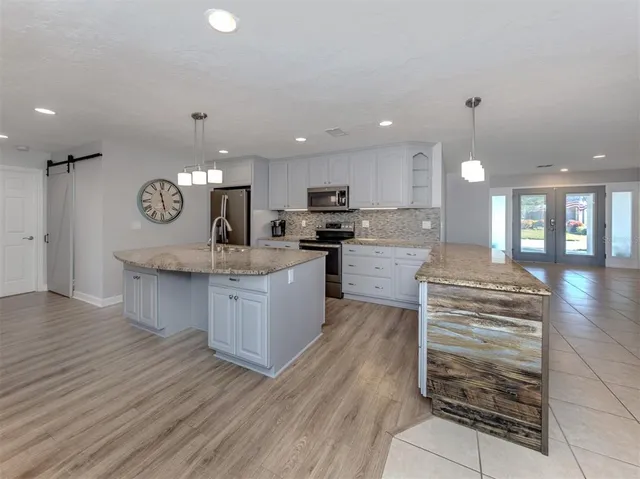 a view of kitchen with cabinets and window