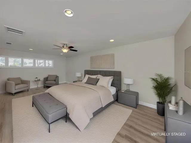 a bed sitting in a bedroom next to a window