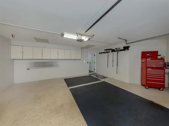 a room with pool table and windows