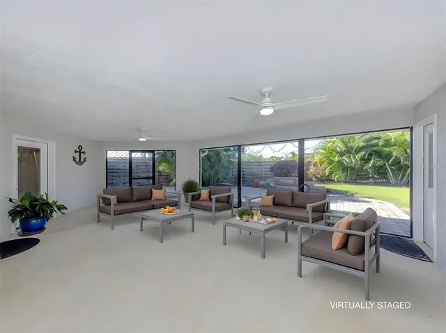 an empty room with furniture and a floor to ceiling window