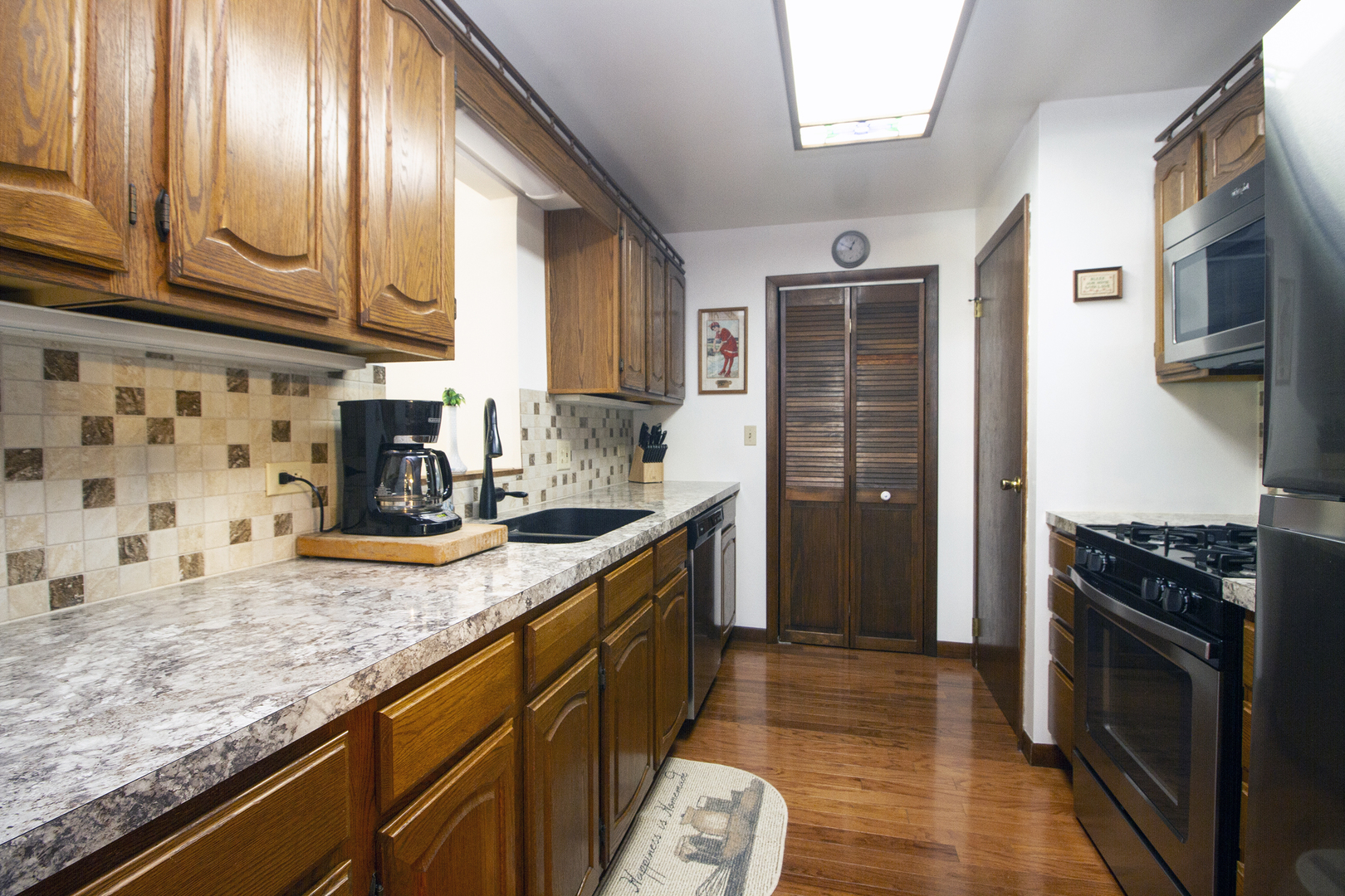 23765 South Loomis Street Crete, IL 60417 - Photo 15 of 23 a kitchen with stainless steel appliances granite countertop a stove and a sink