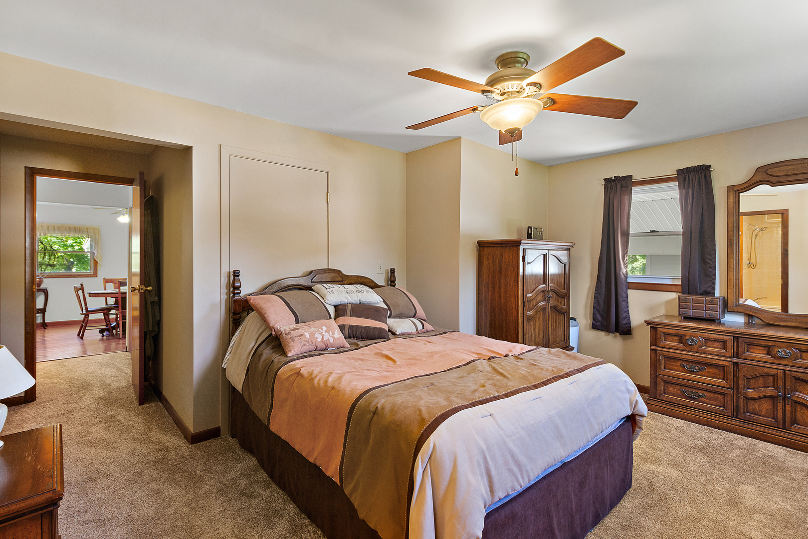 23765 South Loomis Street Crete, IL 60417 - Photo 17 of 23 a bedroom with a large bed and a chandelier