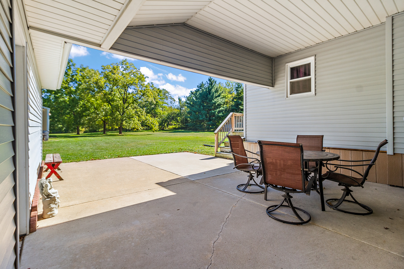 23765 South Loomis Street Crete, IL 60417 - Photo 9 of 23 a view of a patio with table and chairs and potted plants