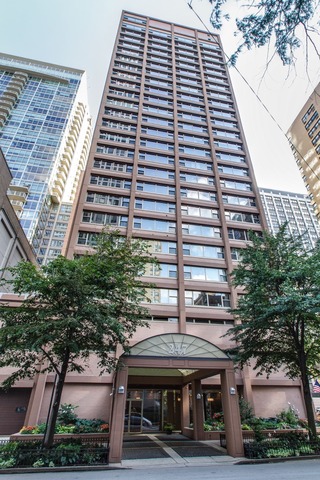 a front view of a building with a garden