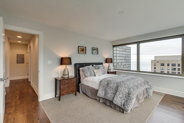 247 East Chestnut Street, Unit 2503 Chicago, IL 60611 - Photo 12 of 24 a bedroom with a bed and window