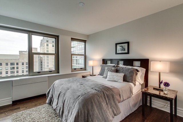 247 East Chestnut Street, Unit 2503 Chicago, IL 60611 - Photo 16 of 24 a bedroom with a bed and a large window