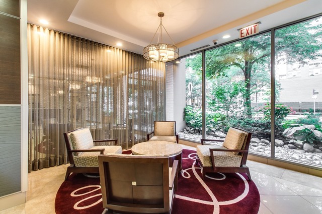 247 East Chestnut Street, Unit 2503 Chicago, IL 60611 - Photo 18 of 24 a dining room with furniture a chandelier and glass door
