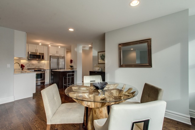 247 East Chestnut Street, Unit 2503 Chicago, IL 60611 - Photo 7 of 24 a view of a dining room with furniture and wooden floor