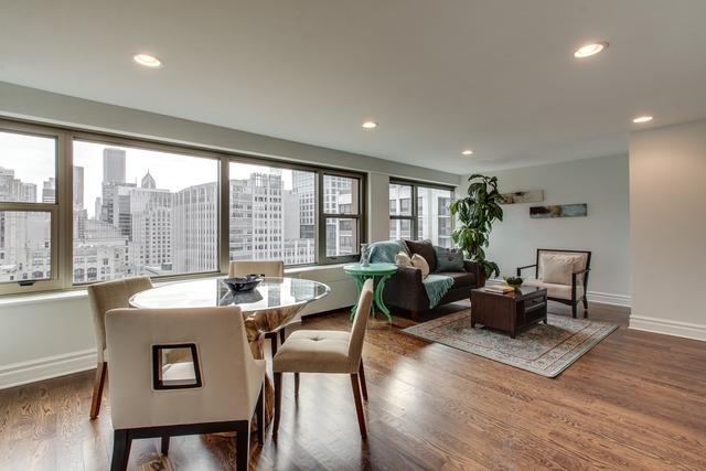 247 East Chestnut Street, Unit 2503 Chicago, IL 60611 - Photo 8 of 24 a living room with furniture and a large window