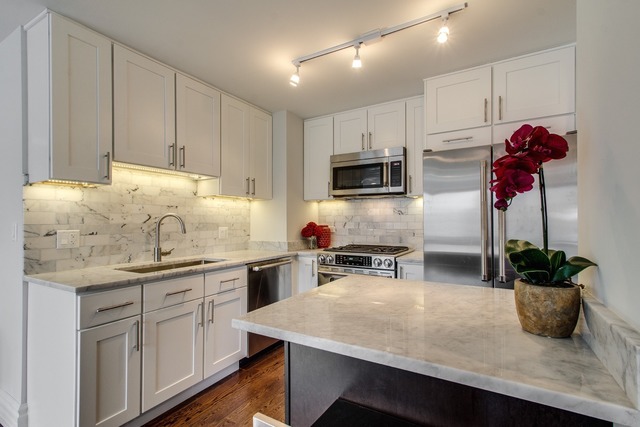 247 East Chestnut Street, Unit 2503 Chicago, IL 60611 - Photo 10 of 24 a kitchen with a sink a microwave and cabinets