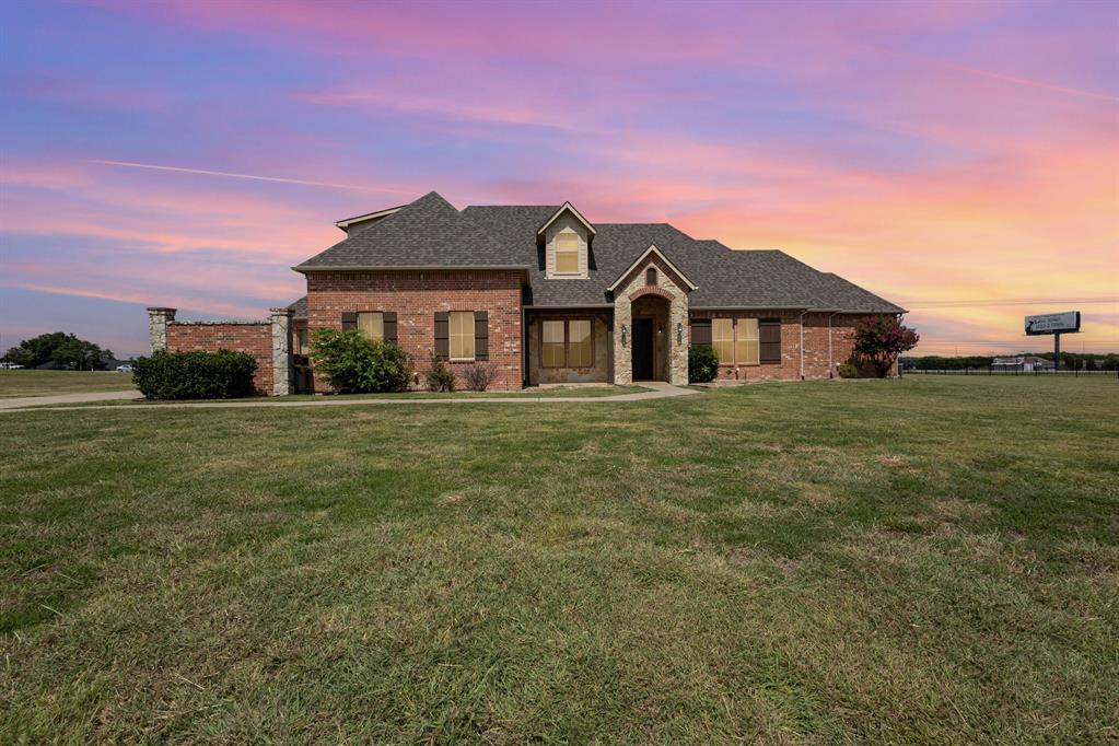 123 Ranch House Road Rockwall, TX 75032 - Photo 1 of 23 a front view of a house with a garden