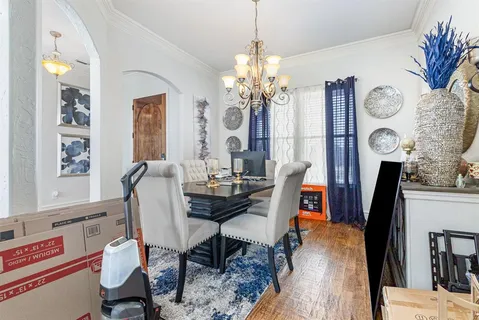 a living room with furniture kitchen view and a large window