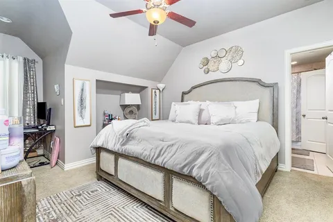 a large bed sitting in a bedroom and chandelier
