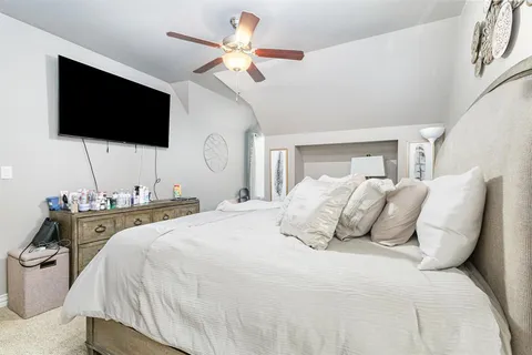 a bedroom with a bed and a flat screen tv