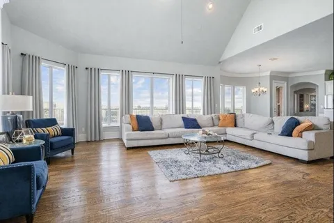 a large kitchen with stainless steel appliances granite countertop a large window and wooden floors