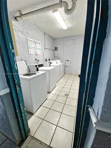 a kitchen with a sink a stove a washer and dryer