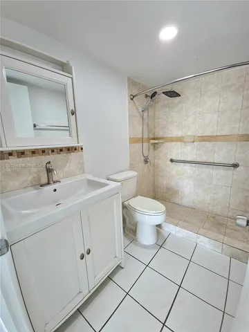 a bathroom with a toilet sink and a mirror