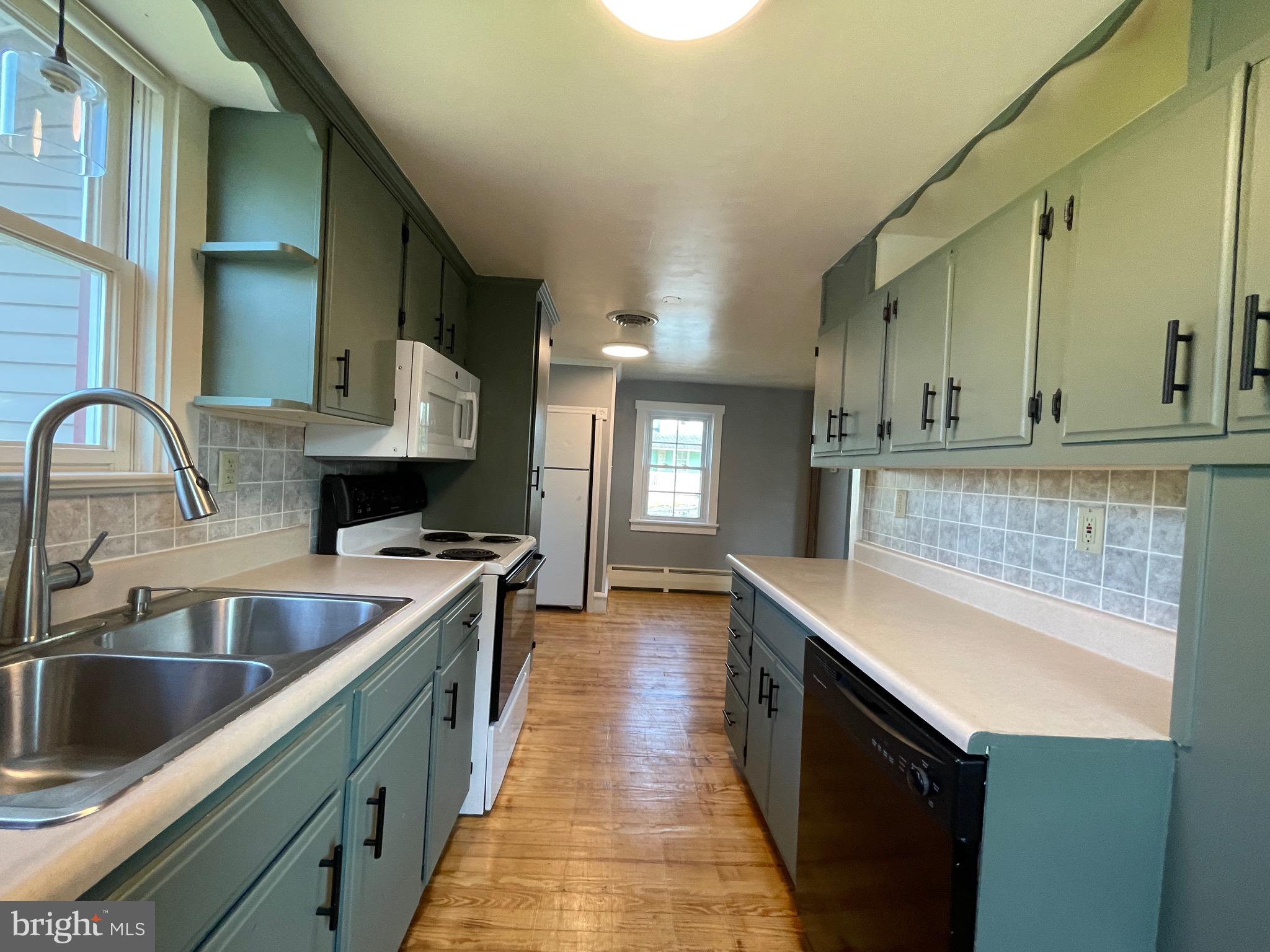 308 Highway 897 Reinholds, PA 17569 - Photo 14 of 36 a kitchen with a sink stove top oven and refrigerator