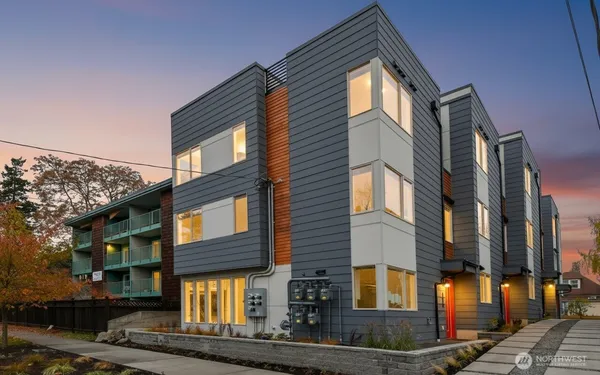 a front view of a residential apartment building with a yard