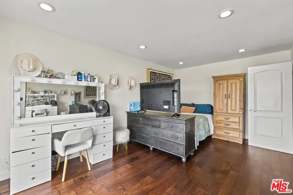 a bedroom with a balcony a bed and a flat screen television