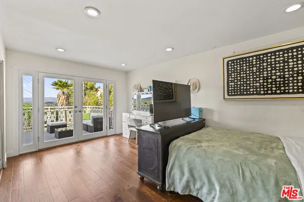 a spacious bedroom with a bed and a desk