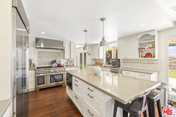 a dining room with furniture a chandelier and wooden floor