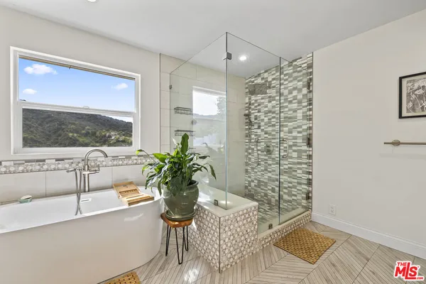 a bath room with a bathtub and a shower