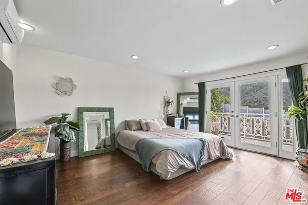 a bedroom with a bed and a table