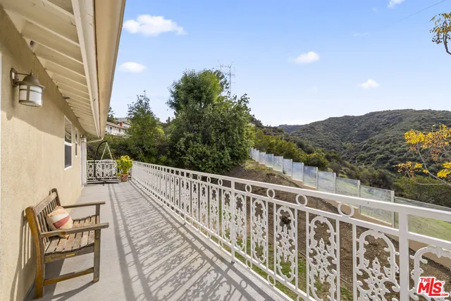 a view of balcony with furniture