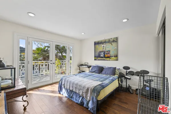 a bedroom with a large bed and a large window