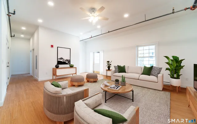 a living room with furniture and a chandelier