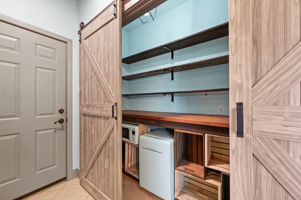 508 Chandler Road Keller, TX 76248 - Photo 11 of 39 Fantastic pantry with barn door access comes with a beverage refrigerator and a microwave. The space includes under-counter lighting and multiple electrical outlets.