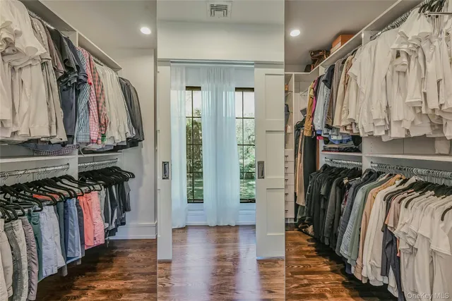 a view of walk in closet with clothes and shoes