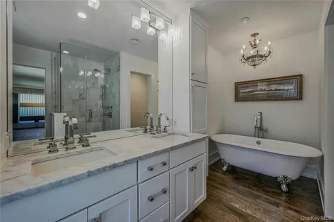 a bathroom with a double vanity sink and a mirror