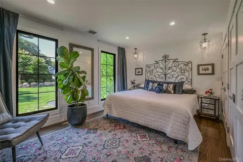 a bedroom with a large bed and a window