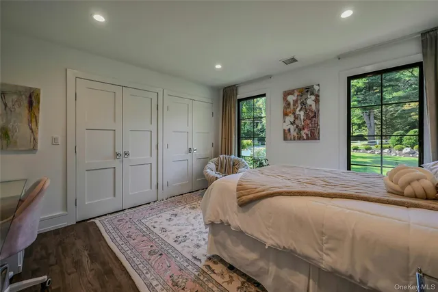 a bedroom with a large bed and a window