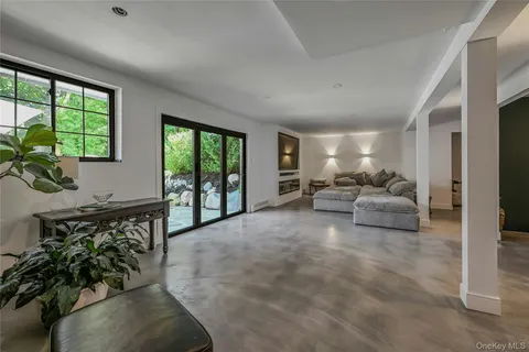 a living room with furniture and large windows