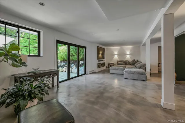 a living room with furniture and large windows