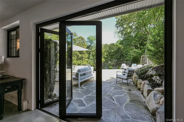 a balcony with chairs and with view of living room