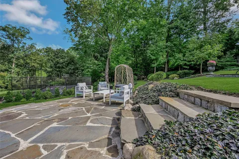 a view of a backyard with sitting area